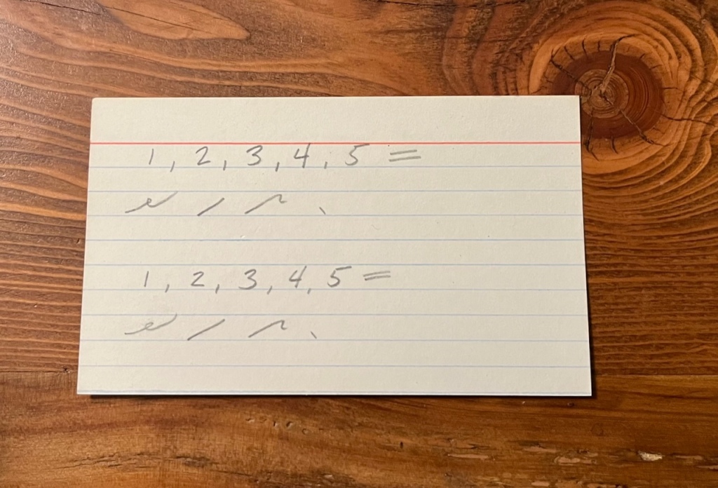 index card with shorthand notation
